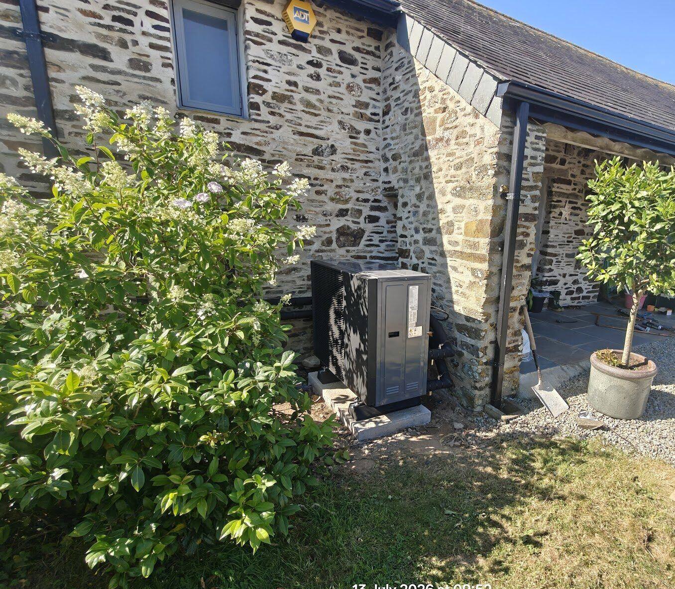 Heat pump installed at a barn conversion garden